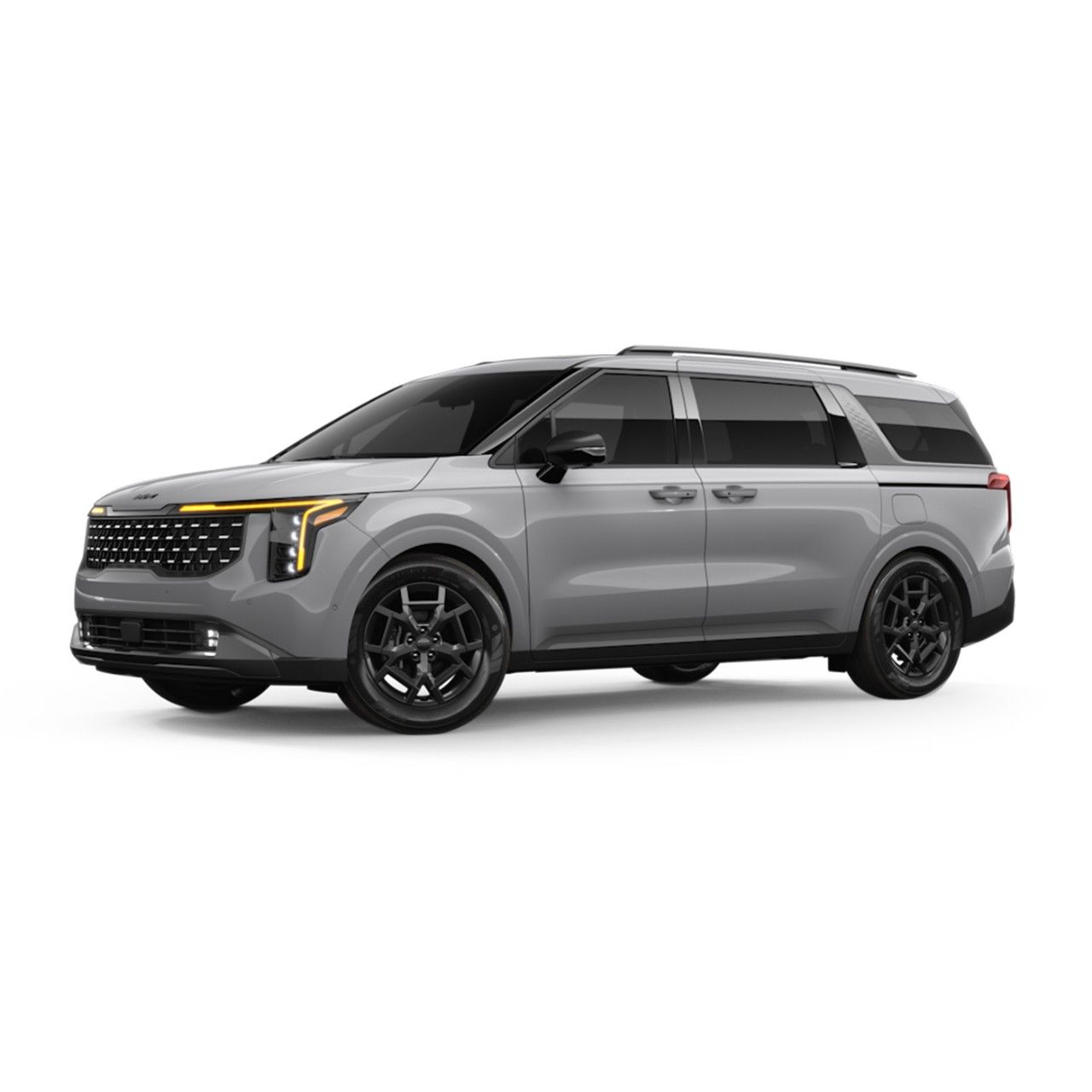 Vista de tres cuartos de los asientos de sala VIP en la segunda fila del Kia Carnival 2025 con el apoyapiernas extendido hacia arriba y el techo corredizo por encima