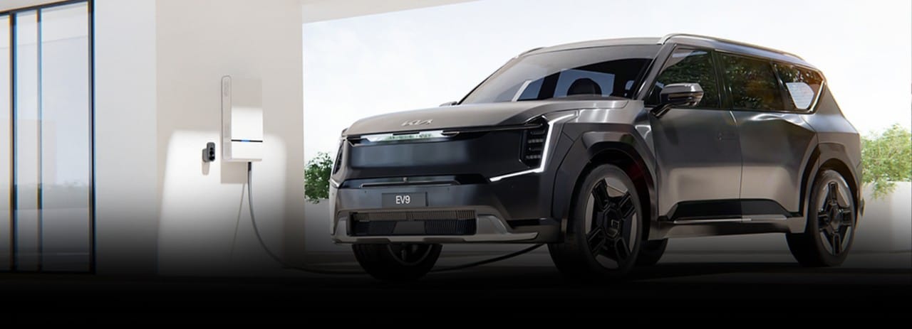2024 Kia EV9 utilizing the vehicle to home capability to power up a Wallbox backup generator, three-quarter view