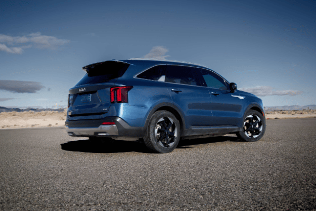 2025 Kia Sorento Hybrid in blue, three-quarter back view, parked on a road in the desert
