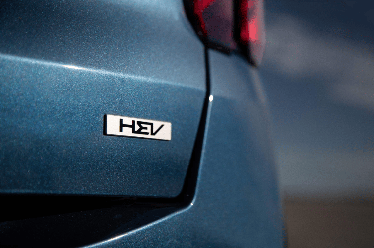 2025 Kia Sorento Hybrid in blue, zoomed in view of the trunk door to reveal the HEV emblem